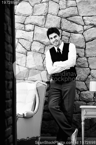 Image of indoor portrait of young and happy  businessman 