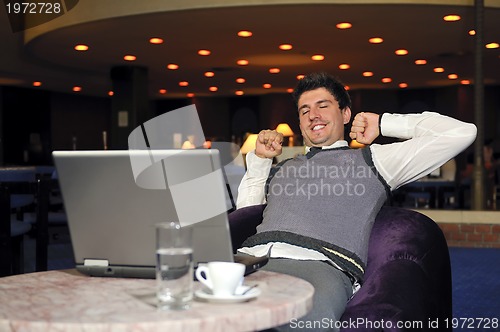 Image of young businessman working on laptop
