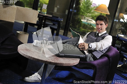 Image of young businessman working on laptop