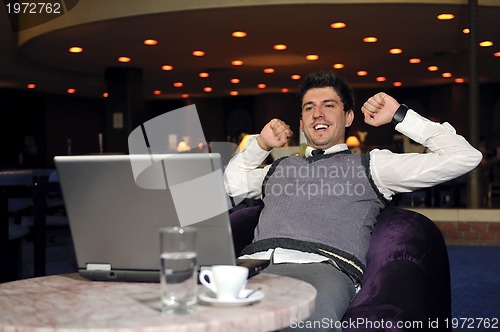 Image of young businessman working on laptop