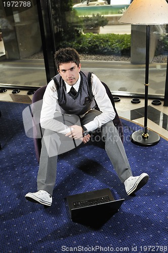 Image of young adult working on laptop