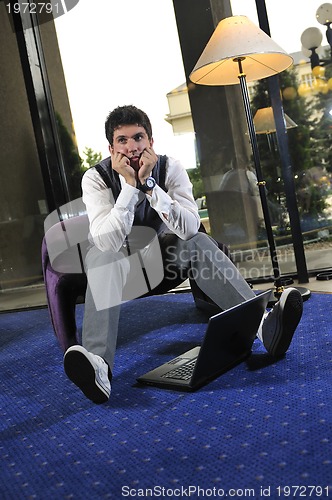 Image of young adult working on laptop