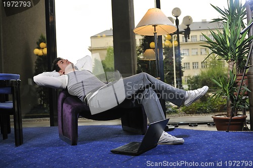 Image of young adult working on laptop