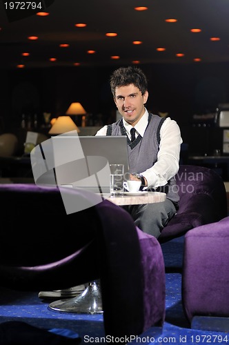 Image of young businessman working on laptop