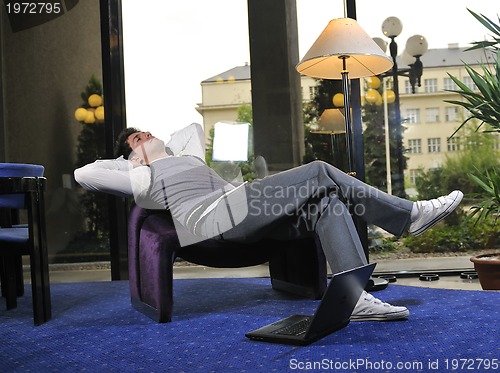 Image of young adult working on laptop