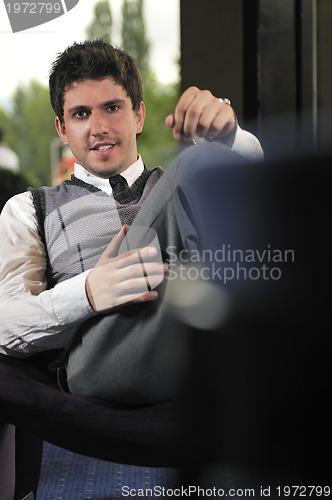 Image of young adult working on laptop