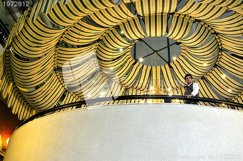 Image of indoor portrait of young and happy  businessman 