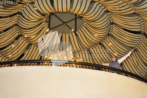 Image of indoor portrait of young and happy  businessman