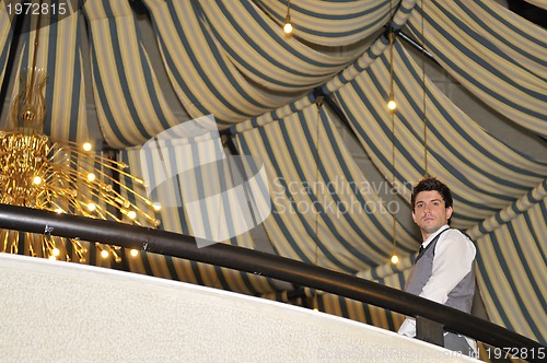 Image of indoor portrait of young and happy  businessman