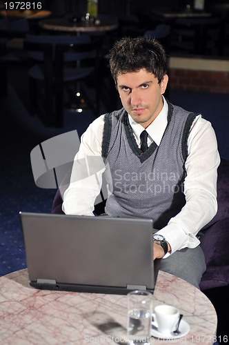Image of young businessman working on laptop