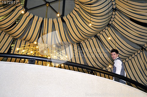 Image of indoor portrait of young and happy  businessman 