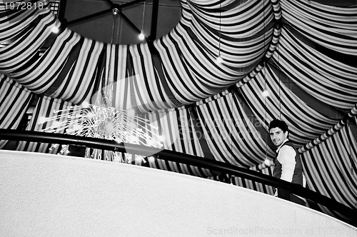 Image of indoor portrait of young and happy  businessman 