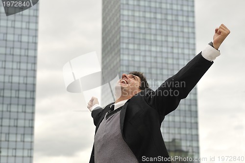 Image of Photo of happy winner businessman  screaming from joy 