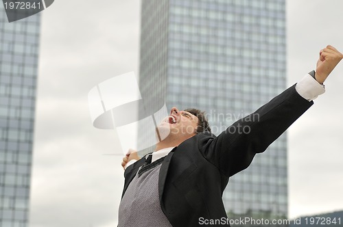 Image of Photo of happy winner businessman  screaming from joy