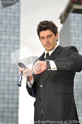 Image of Photo of happy winner businessman  talking on mobile phone