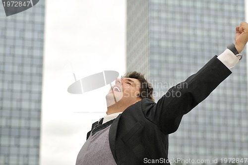 Image of Outdoor portrait of young and happy  businessman