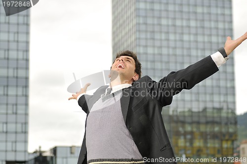 Image of Outdoor portrait of young and happy  businessman