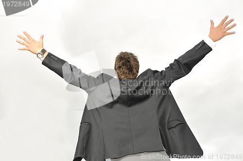 Image of Outdoor portrait of young and happy  businessman