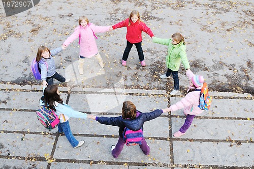 Image of friendship and teamwork concept with young schoolgirls group