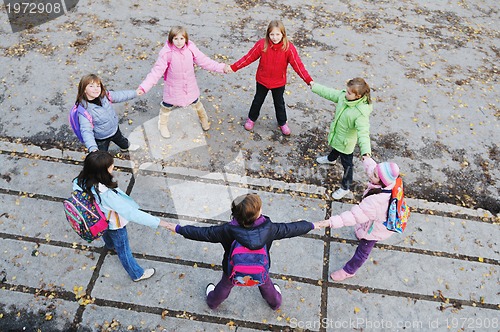 Image of friendship and teamwork concept with young schoolgirls group
