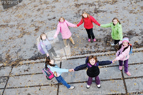 Image of friendship and teamwork concept with young schoolgirls group