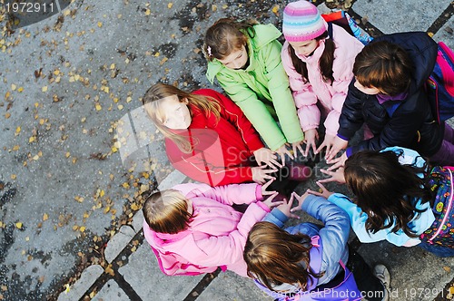 Image of friendship and teamwork concept with young schoolgirls group
