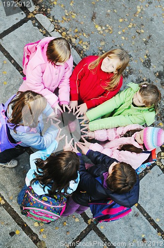 Image of friendship and teamwork concept with young schoolgirls group