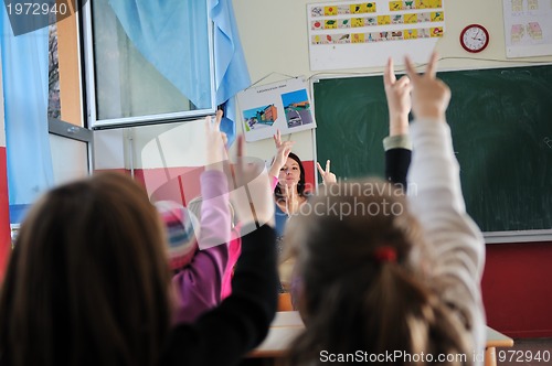 Image of happy teacher in  school classroom 