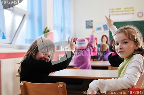 Image of happy teacher in  school classroom 