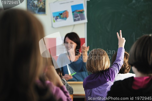 Image of happy teacher in  school classroom 