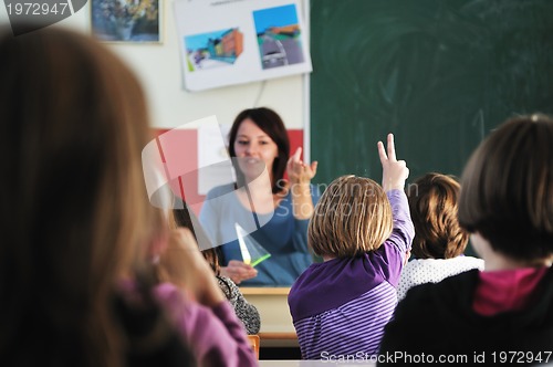 Image of happy teacher in  school classroom 