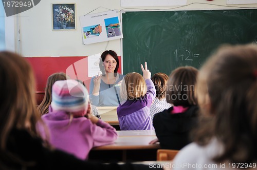 Image of happy teacher in  school classroom 