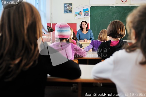 Image of happy teacher in  school classroom 