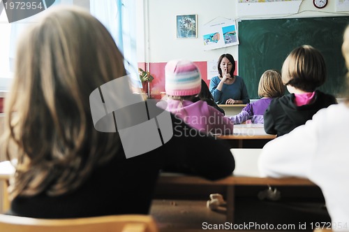 Image of happy teacher in  school classroom 