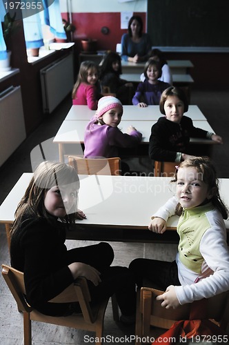 Image of happy teacher in  school classroom 