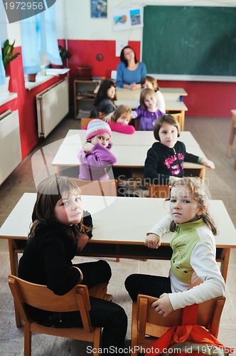 Image of happy teacher in  school classroom 