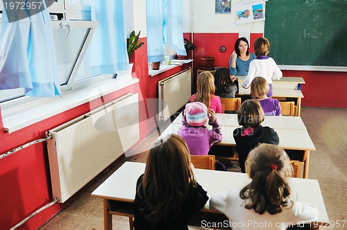 Image of happy teacher in  school classroom 