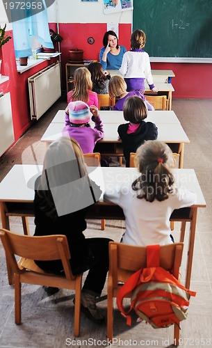 Image of happy teacher in  school classroom 