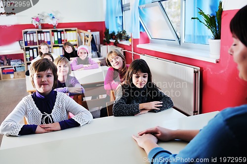 Image of happy teacher in  school classroom 