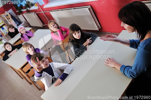 Image of happy teacher in  school classroom 