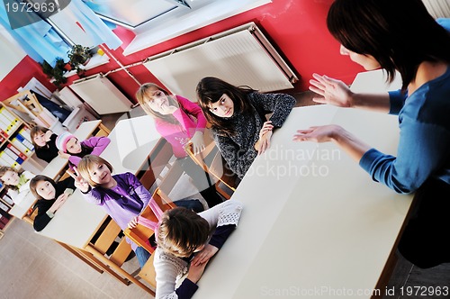 Image of happy teacher in  school classroom 