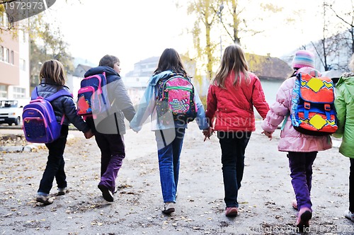 Image of school girls running away 