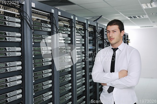 Image of young engeneer in datacenter server room
