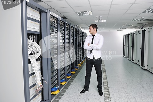 Image of young engeneer in datacenter server room