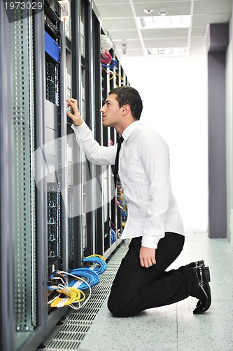 Image of young engeneer in datacenter server room