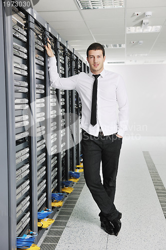 Image of young engeneer in datacenter server room