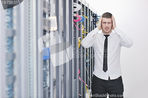 Image of young engeneer in datacenter server room