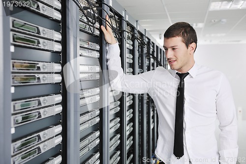 Image of young engeneer in datacenter server room