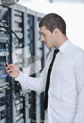 Image of young engeneer in datacenter server room