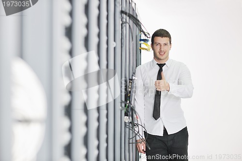 Image of young engeneer in datacenter server room